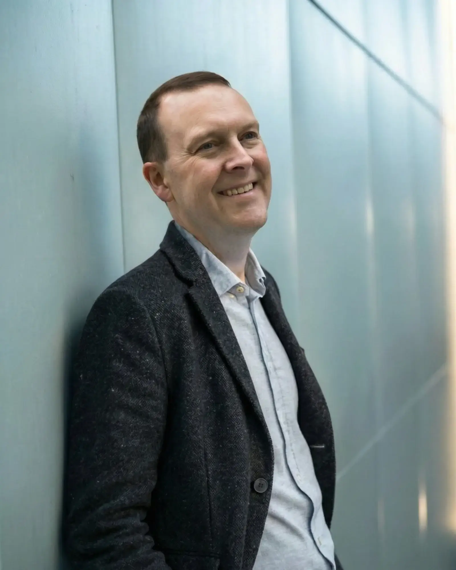 Smart AI Marcus blog author and AI expert standing against office wall